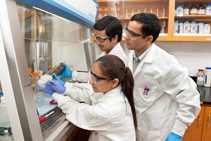 Photo of Dr. Deb Jaisi and two students in the lab